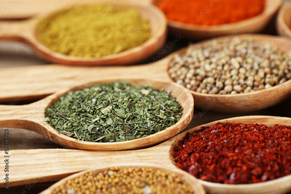 Assortment of spices in wooden spoons, close-up Assortment of spices in wooden spoons, close-up