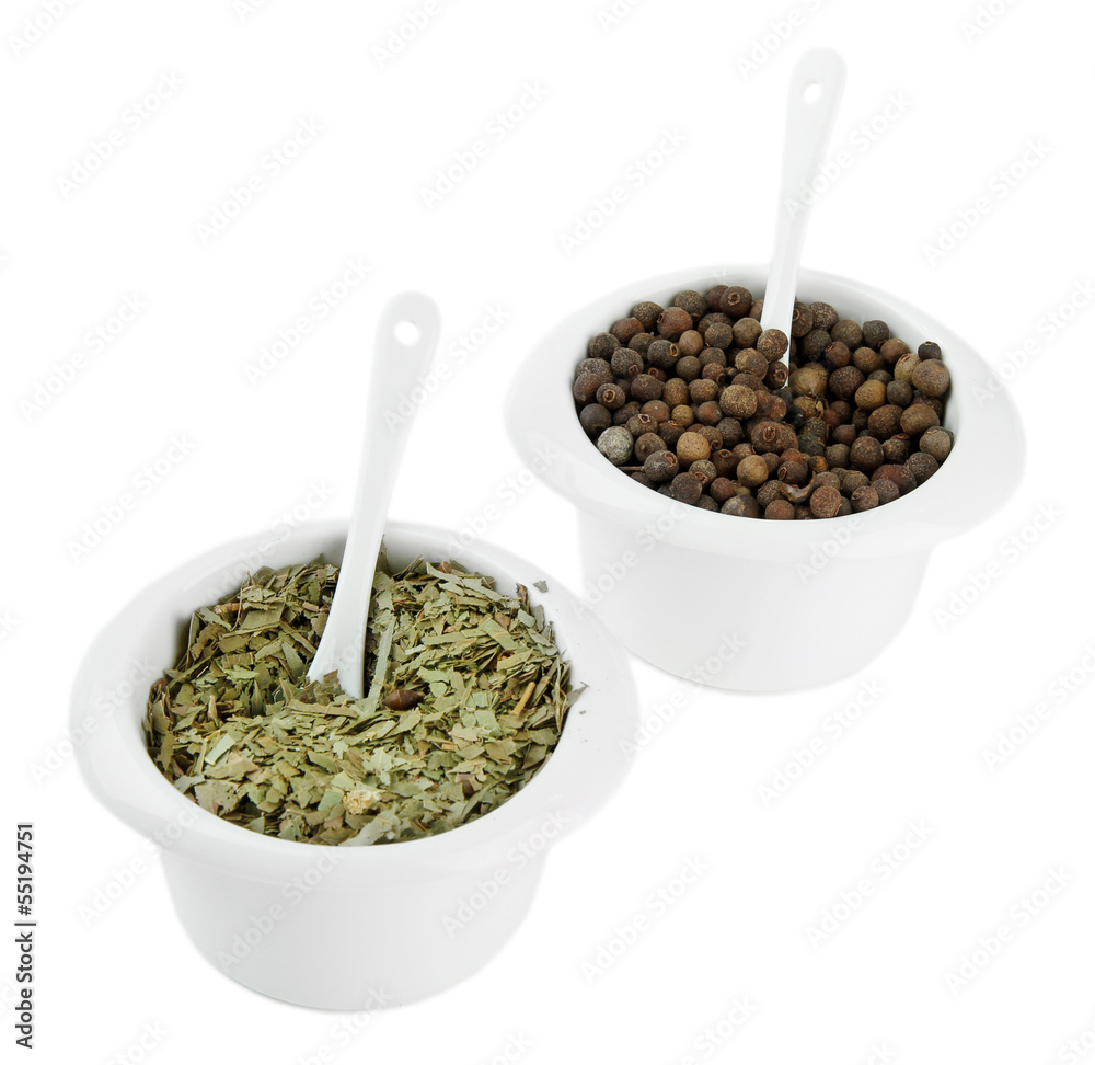 Spices in white bowls, on wooden board, isolated on white Spices in white bowls, on wooden board, isolated on white