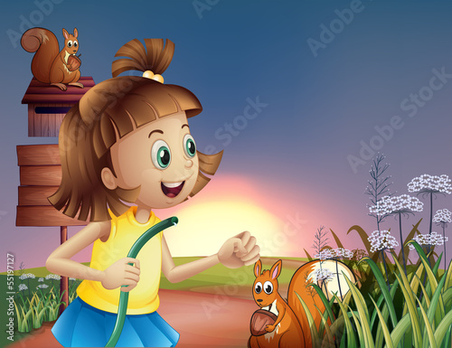 A young girl at the hilltop with a water hose