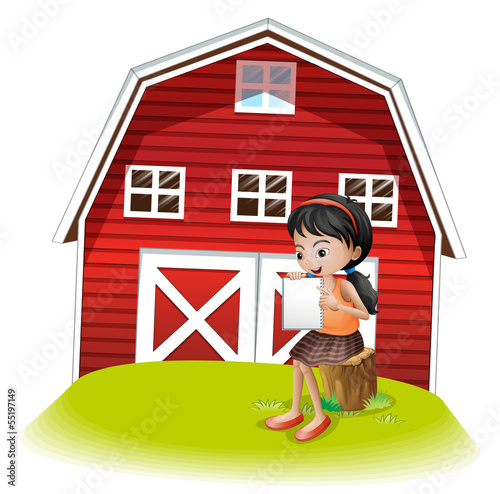 A girl reading in front of the barnhouse