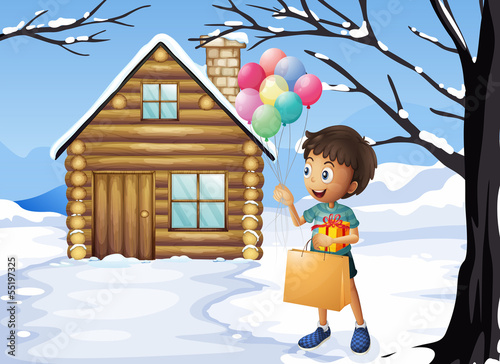 A boy holding a bag and balloons