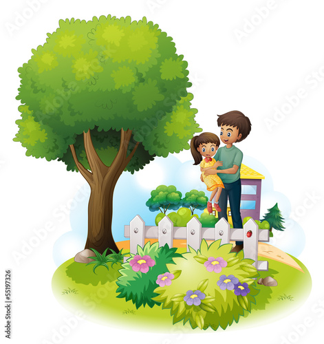 A father and his daughter near the wooden fence and the giant tr