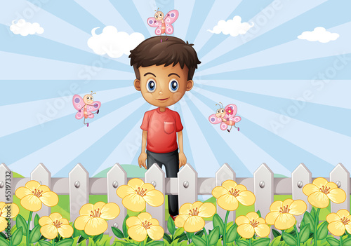 A boy in the garden with a fence