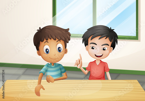 Two boys near the wooden table
