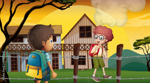 Two students talking near the barbwire fence