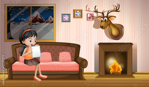 A girl studying inside the house near the fireplace