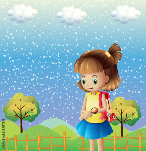 A child with a backpack and a watch near the hills