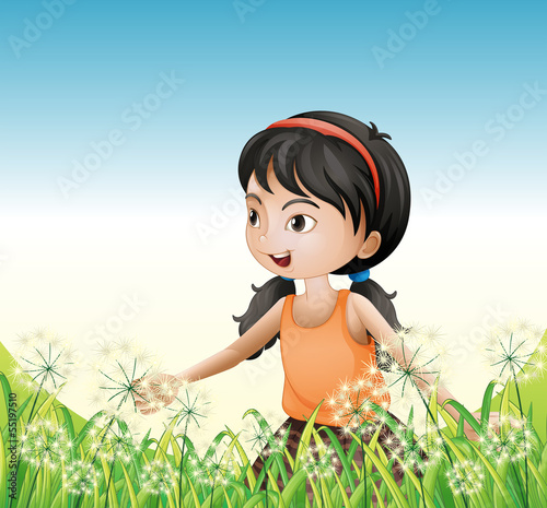 A young girl wearing an orange sando above the hill