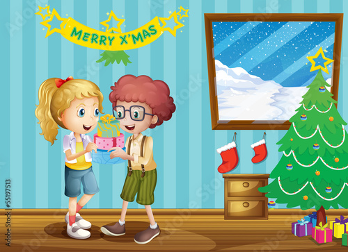 Two adorable kids exchanging their christmas gifts
