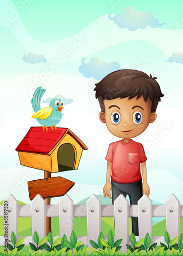 A boy near the pethouse with a bird and a wooden arrowboard
