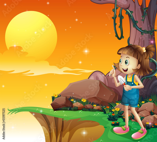 A young girl near the cliff holding a small shovel