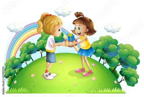 Two girls exchanging gifts at the hilltop