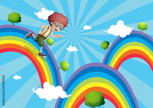 A boy walking at the top of the rainbow