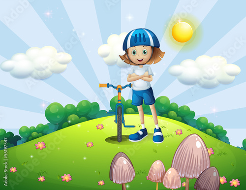 A hilltop with a female biker wearing a helmet
