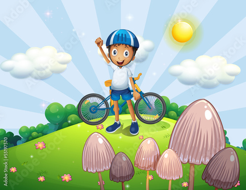 A male biker at the top of the hill