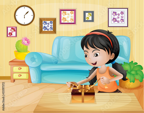 A lady opening her gift in the living room