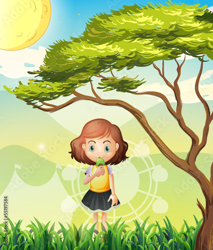 A small girl near the big tree