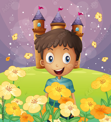 A happy boy in front of the castle at the hilltop