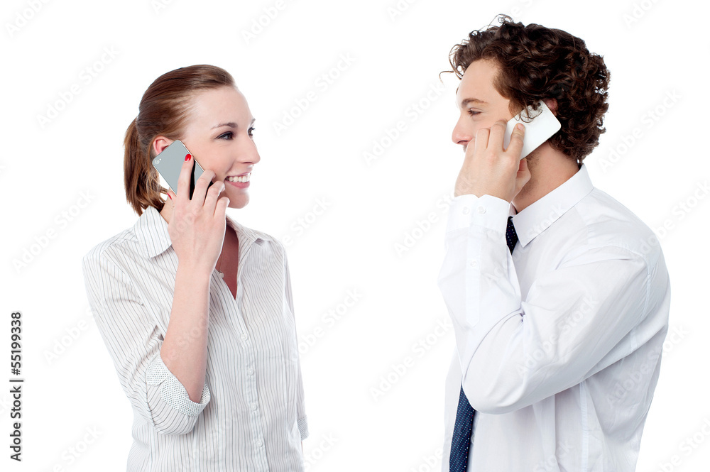 Office executives engaged over a phone call Office executives engaged over a phone call