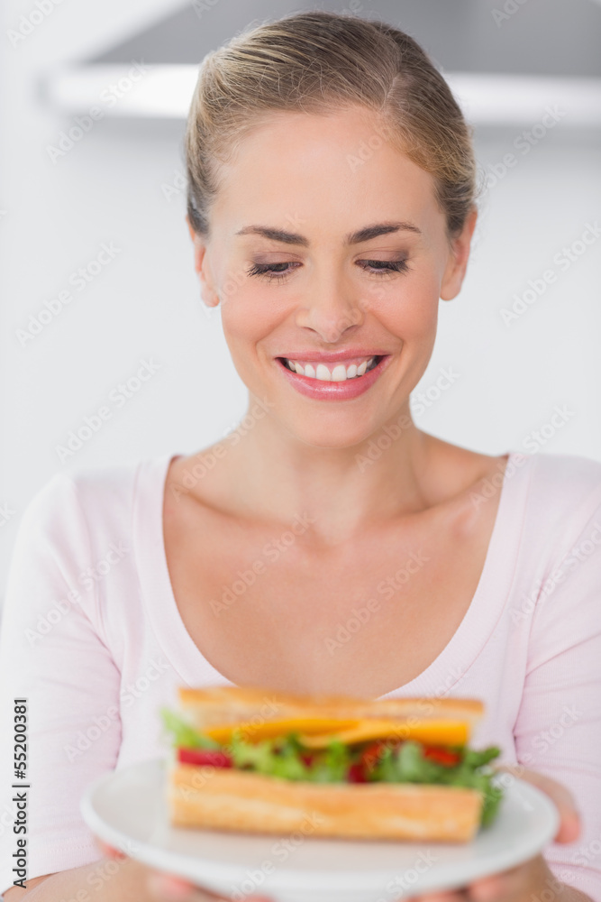 Cheerful blonde with sandwich