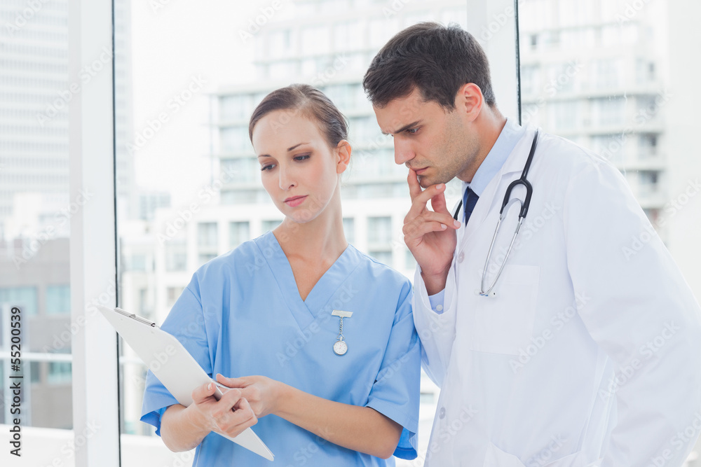 Focused surgeon and doctor working together Focused surgeon and doctor working together