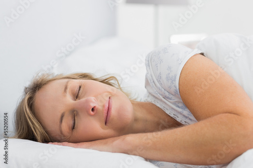 Peaceful blonde woman sleeping in bed