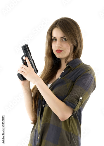 Young beautiful woman holding a gun on white background