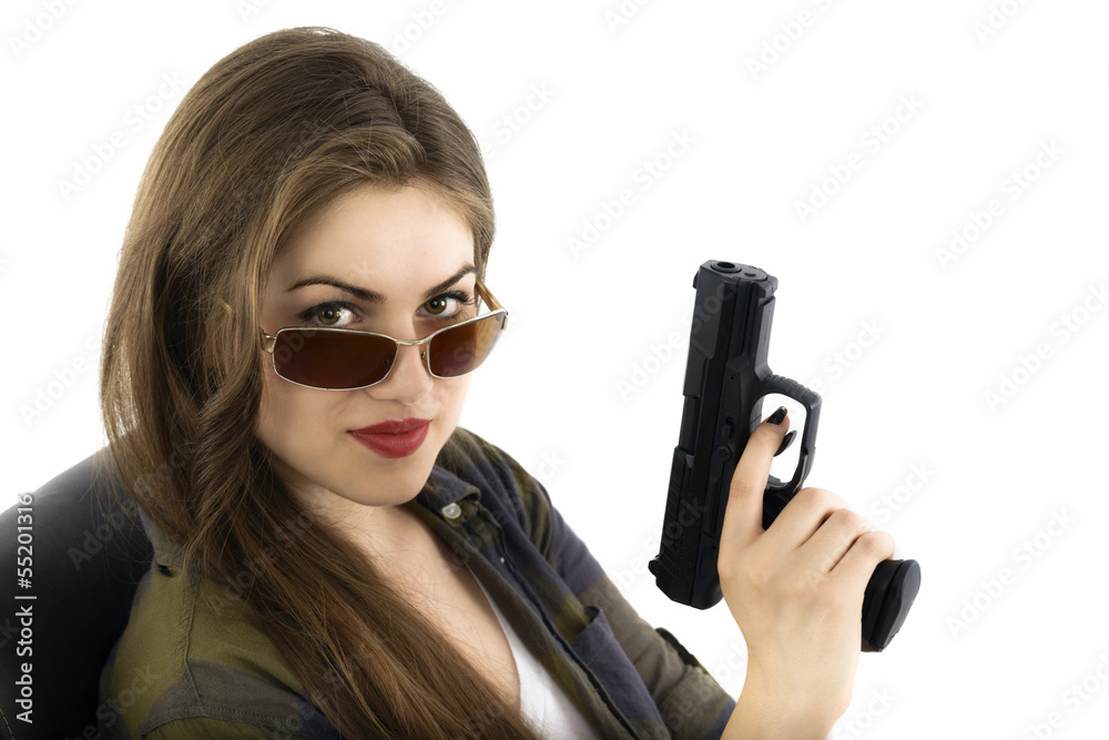 Young beautiful woman holding a gun on white background Young beautiful woman holding a gun on white background