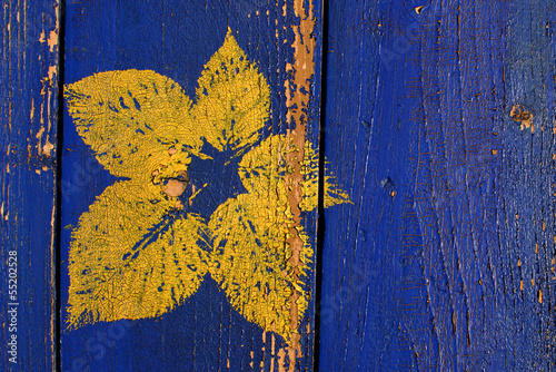 printed yellow leave on an old wooden covering