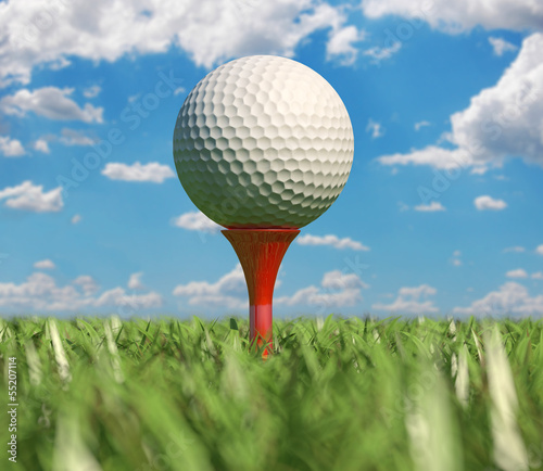 Golf ball isolated on tee in the grass.