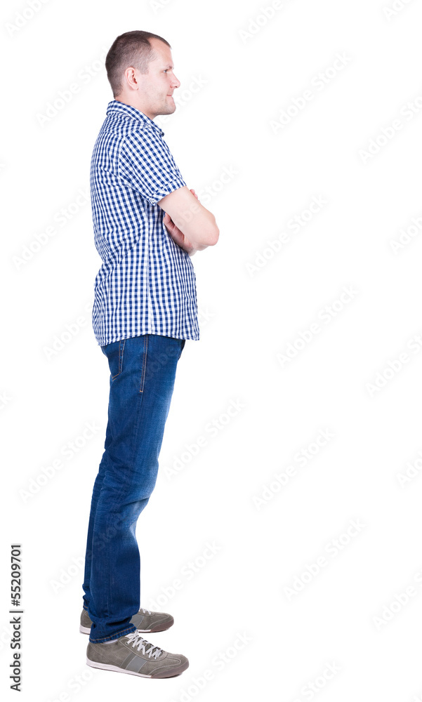 Fototapeta premium Back view of handsome man in shirt looking up.