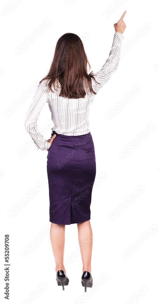 Back view of young brunette woman pointing at wall. Back view of young brunette woman pointing at wall.