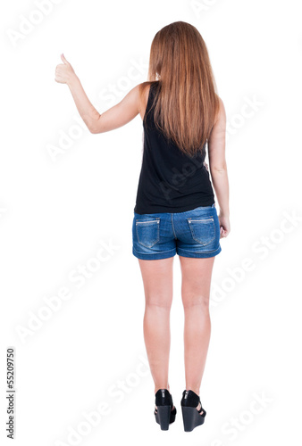 Back view of woman thumbs up.