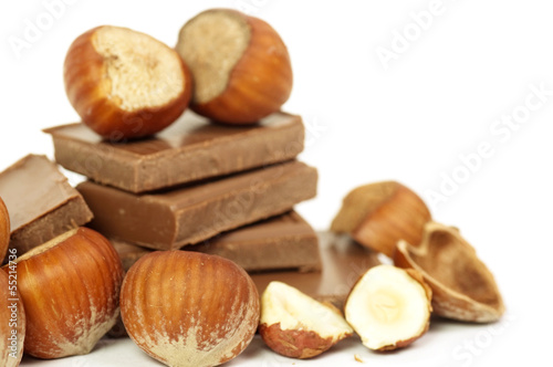 A stack of chocolate with hazelnuts on a white background