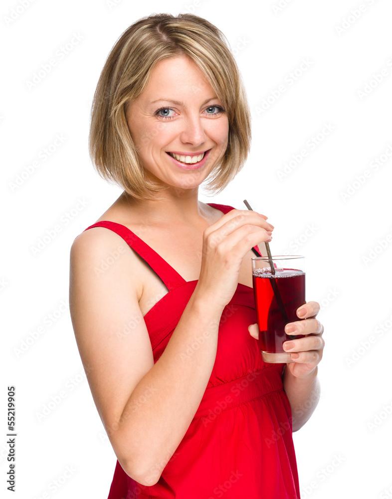 Young woman is drinking cherry juice Young woman is drinking cherry juice