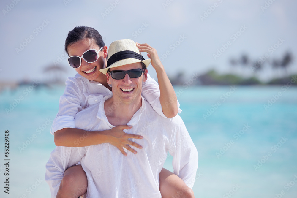 happy young couple have fun on beach