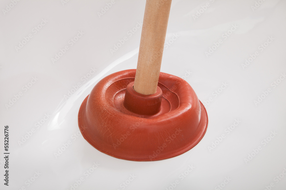Plumber using plunger in sink Plumber using plunger in sink