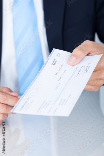 Businessman Holding Cheque