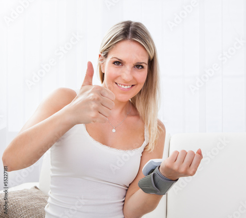 Woman measuring her blood pressure