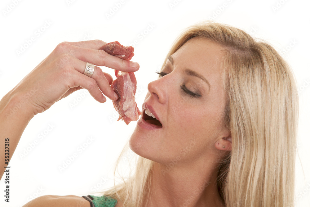 Woman eating raw meat