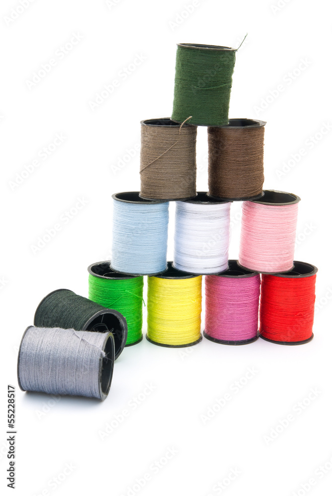 colorful bobbins stack up on white background colorful bobbins stack up on white background