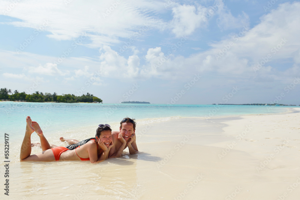 happy young couple have fun on beach