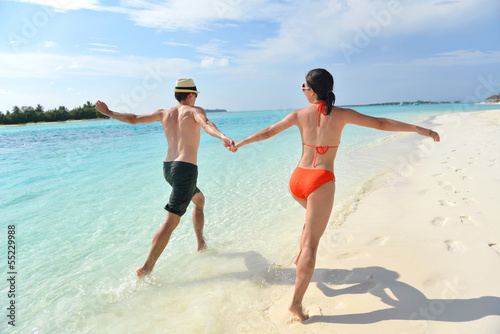 happy young couple have fun on beach