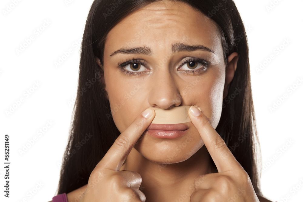 patch under her nose because of bad waxing her mustache Stock Photo