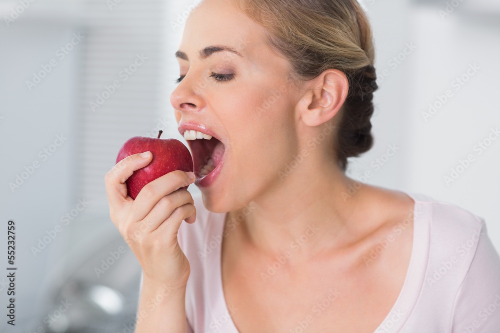 Pretty woman munching apple Pretty woman munching apple