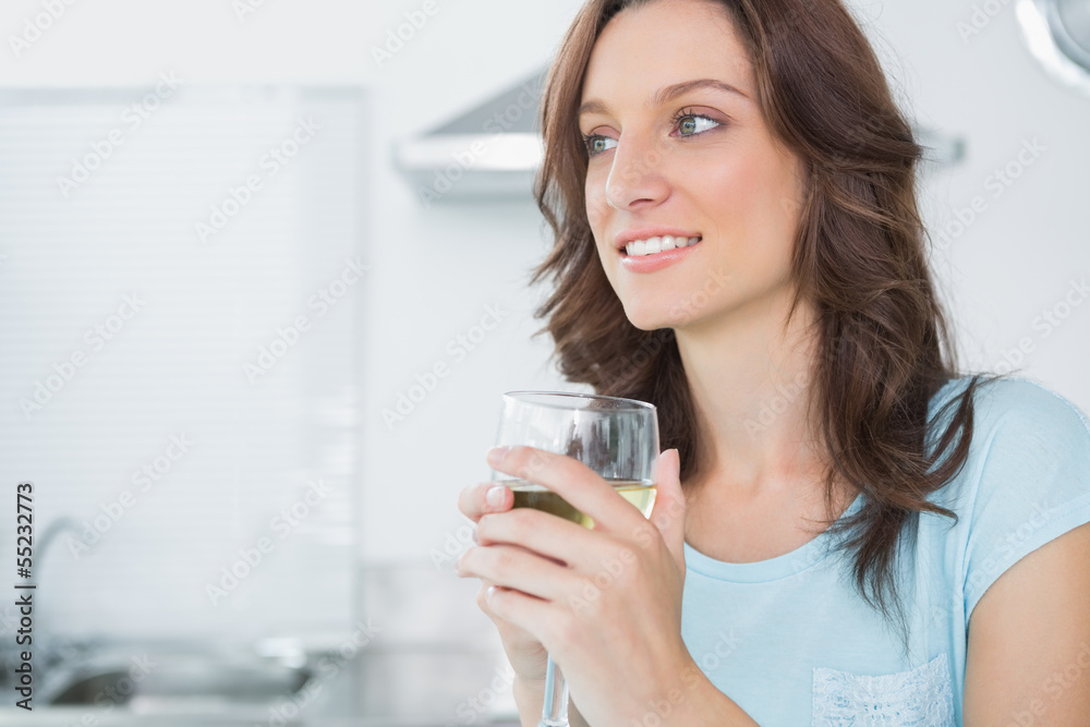 Radiant brunette drinking white wine Radiant brunette drinking white wine