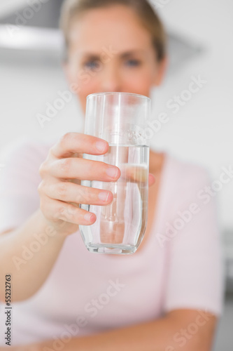 Blonde woman offering water