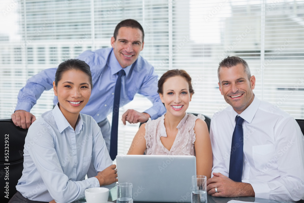 Cheerful colleagues around laptop posing Cheerful colleagues around laptop posing