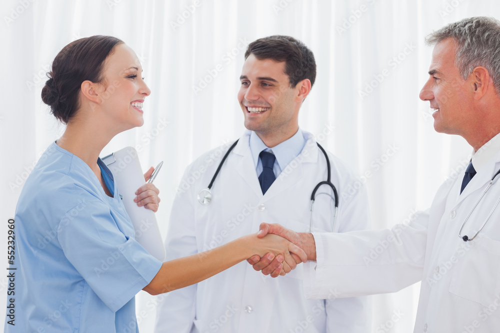 Surgeon thanking the doctor for helping her