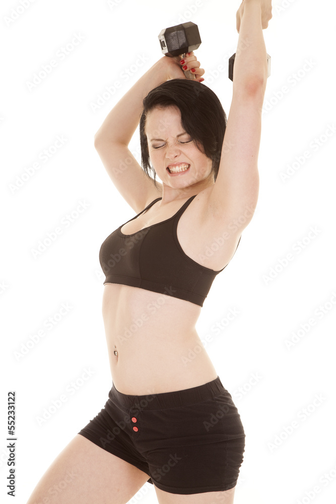 Woman fitness black outfit weights behind head hard